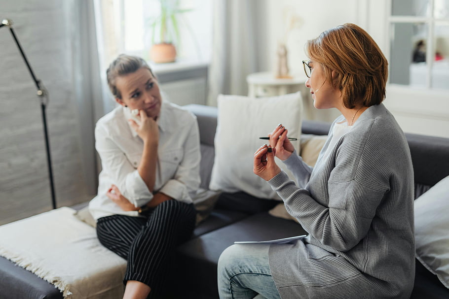 psychologist-patient-therapist-thoughtful-conversation-couch-cozy-room-women-mental-health-counseling-session-professional-therapy